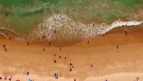 People-rest-on-a-beautiful-sandy-beach-in-Portugal,-Praia-do-Beliche,-Sagres,-aerial-view