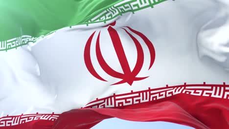 Irani-flag-waving-at-wind-in-slow-in-blue-sky,-loop