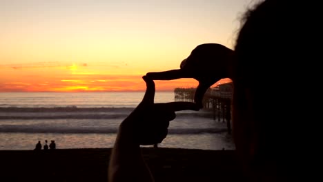 Framing-sunset-by-the-ocean-in-slow-motion