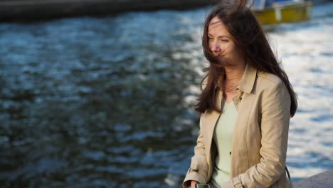 Wind-play-with-woman-long-hair,-boat-pass-by