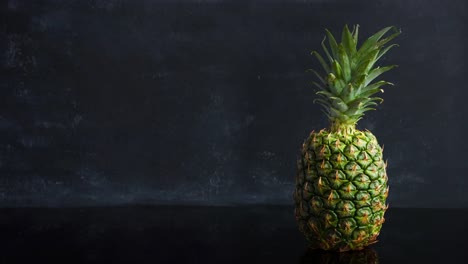 Stop-motion-ripe-tropical-fruit-pineapple-on-a-black-background.-Time-lapse-food-loop-footage