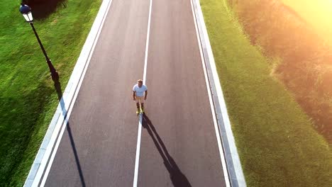 The-elderly-man-rollerblading-in-the-picturesque-park.-quadrocopter-shot