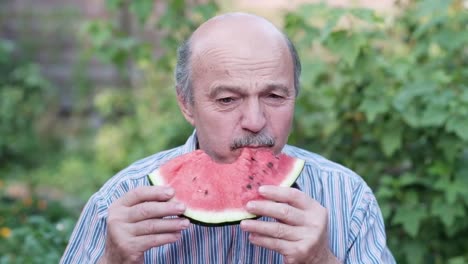 old-man-eating-watermelon-on-hot-summer-day.