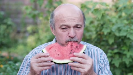 Alter-Mann-Essen-Wassermelone-an-heißen-Sommertag.