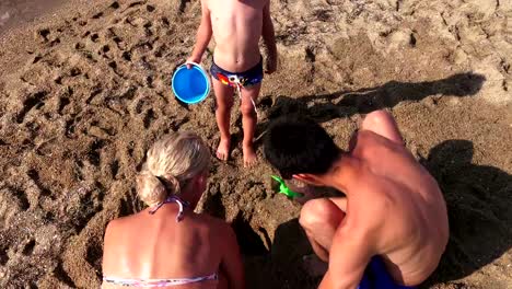 Happy-family:-father,-mother-and-small-child--on-the-sea-beach,-Greece