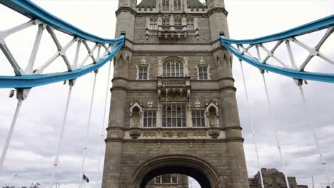 Low-angle-drone-view-shot-under-the-iconic-Tower-Bridge-in-London,-UK