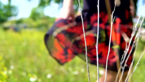 A-young-woman-is-spinning-in-a-meadow-in-a-dress.