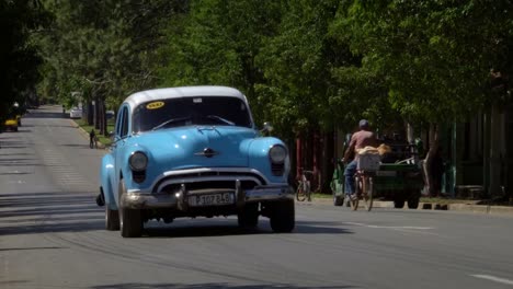 Colorful-Classic-1950's-American-Vintage-Taxi-Cars-driving-in-rural-town-Vinales-valley,-Cuba