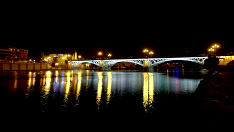 Night-view-of-the-river-in-Seville-(Spain).-Timelapse.