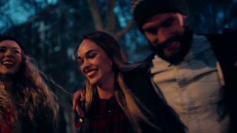 Young-hipster-friends-walking-in-town-on-evening