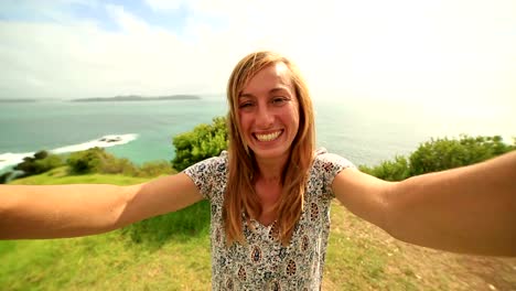 Self-portrait-of-young-woman-on-coastline-hill