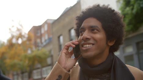 Stylish-Young-Man-Making-Phone-Call-On-City-Street