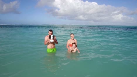 Family-bathing-and-aerial-view-of-ocean