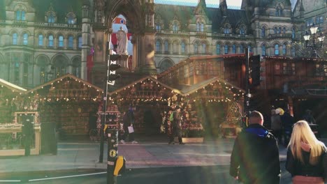 MANCHESTER,UK---DECEMBER-16,-2016.-Shot-of-shoppers-at-the-Christmas-market-in-front-of-the-Manchester-Town-Hall-on-Albert-Square.-December-16,-2016