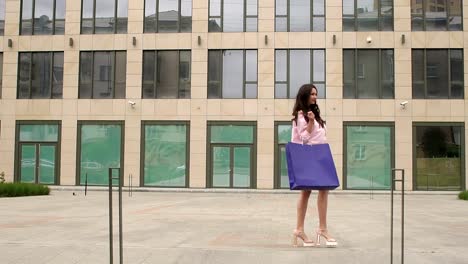 Girl-comes-with-a-blue-bag-near-modern-building.