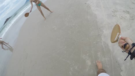 Couple-playing-Frescobol-on-the-beach