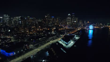 Helicopter-View-of-Seattle-Waterfront-at-Night-in-Vibrant-Lighting