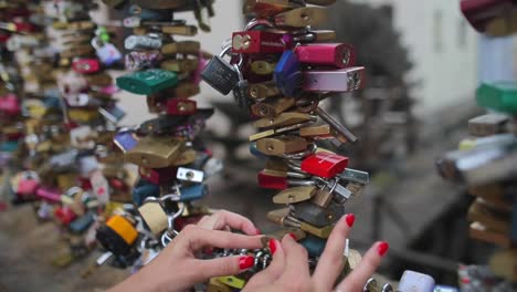 hand-and-colored-padlocks-on-the-bridge