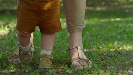 Unrecognizable-Woman-Teaching-Baby-to-Walk