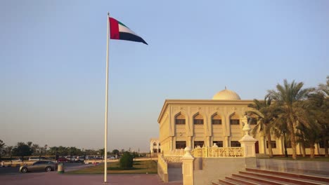 La-bandera-de-Emiratos-Árabes-Unidos-ondeando-en-la-ciudad-de-Sharjah-al-atardecer