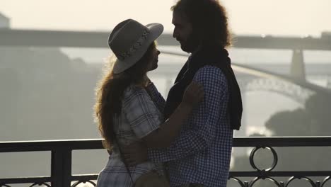 Embracing-and-kissing-couple-on-high-top-bridge