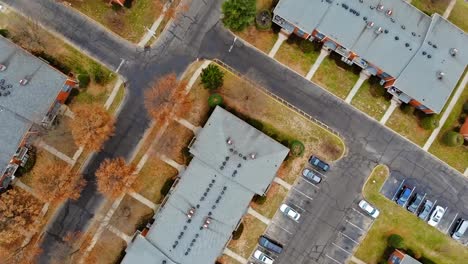 Overhead-aerial-view-of-countryside-town-and-car-park,-buildings-from-the-height-of-bird-flight