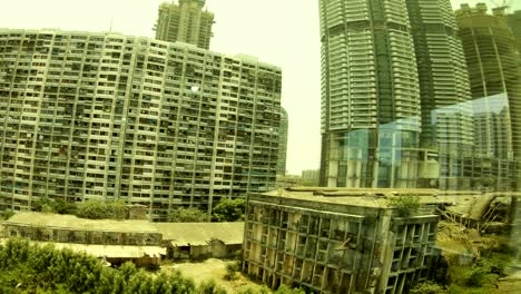 view-on-many-storied-apartment-houses-and-skyscrapers-throw-glass-with-reflection-megapolis-Mumbai