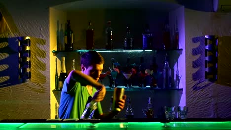 Professional-barman-making-cool,-amazing-tricks-using-shaker-and-bottle,-juggling-standing-behind-the-bar,-catching,-throwing-up,-imitation,-slow-motion