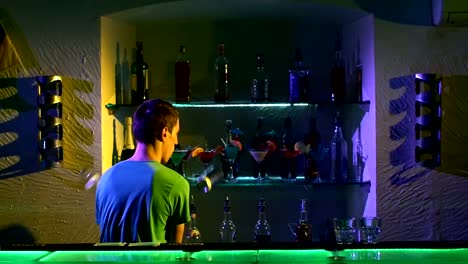 Professional-bartender-making-cool,-amazing-tricks-with-two-glasses,-shaker-and-bottle-standing-behind-the-bar,-catching-on-elbow,-throwing-up,-slow-motion