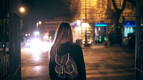 Back-view-of-young-brunette-woman-walking-late-at-night-in-Rome,-Italy-city-centre.-Girl-turns-and-see-the-Colosseum