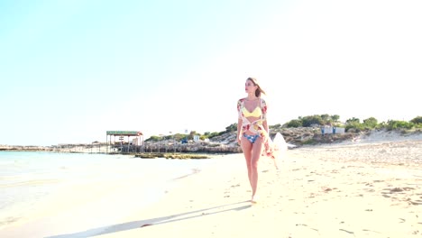 Attractive-young-woman-in-swimsuit-walking-on-tropical-island-vacations