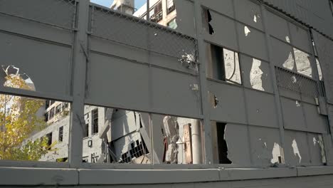 CLOSE-UP:-Broken-windows,-damaged-facade-&-crumbling-walls-in-abandoned-factory