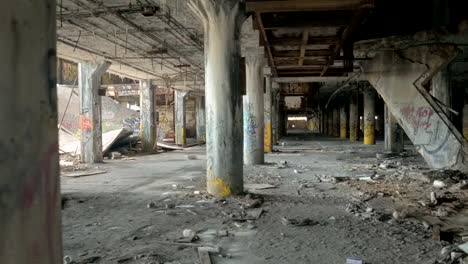 CLOSE-UP:-Spooky-ruined-garage-in-abandoned-Fisher-Body-Plant-automotive-factory