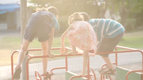 Three-kids-playing-in-a-public-playground-during-sunset