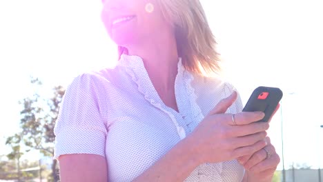 Businesswoman-working-on-digital-device-outdoors