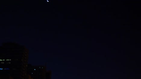 Camera-motion-from-mosque-to-crescent.-Dark-arabian-night.-Mosque-illuminated-with-gold-lights.-Lanterns-at-path-pedestrian-road.