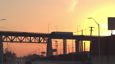 CLOSE-UP-Trucks-hauling-goods-during-the-evening-rush-in-Detroit-industrial-zone