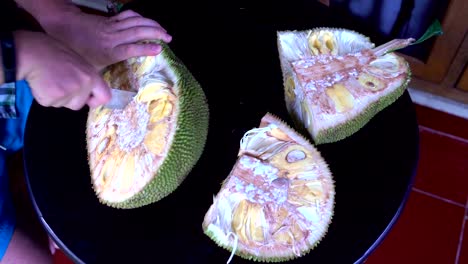 A-man's-hand-cuts-jackfruit-with-a-knife
