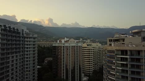 aerial-drone-flight-between-new-modern-residential-living-quarter-apartment-skyscrapers-with-park-and-lots-of-trees