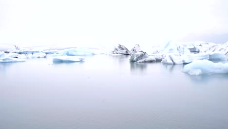 Close-up-on-heart-shape-finger-frame-on-glacier-lagoon-in-Iceland-showing-love-and-respect-to-the-environment