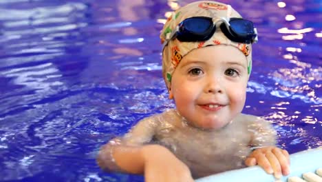 Portrait-of-little-baby-swimming-in-swimming-pool
