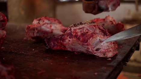 Butcher-cut-Head-meat-of-a-cow-with-a-knife