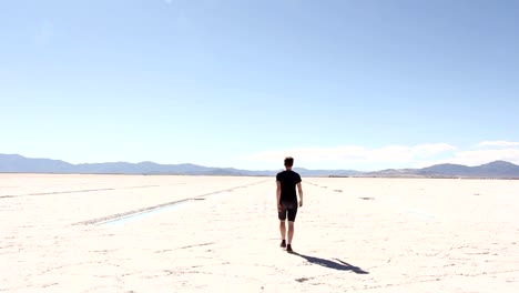 Man-Walking-Away-Across-Salt-Flats