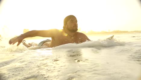 SLOW-MOTION:-Surfer-paddling-at-sunset-in-Sri-Lanka