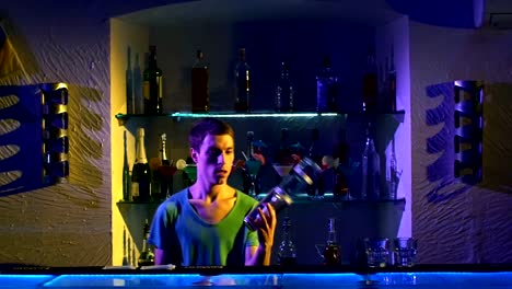 Professional-bartender-making-cool,-amazing-tricks-using-bottle-and-shaker-standing-behind-the-bar,-catching-on-arm,-throwing-up,-slow-motion