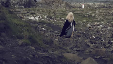 4k-Fantasy-Shot-on-Giant's-Causeway-of-a-Queen-Walking-on-Rocks