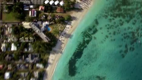 Aerial-view-of-coast-and-family-bathing-in-ocean