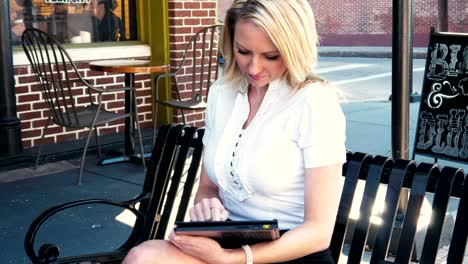 Businesswoman-working-on-digital-device-outdoors