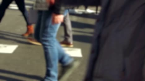 Detail-of-feet-passing-through-a-pedestrian-crossing.