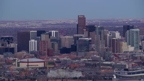 Zoom-out-from-downtown-Denver-buildings-at-dusk